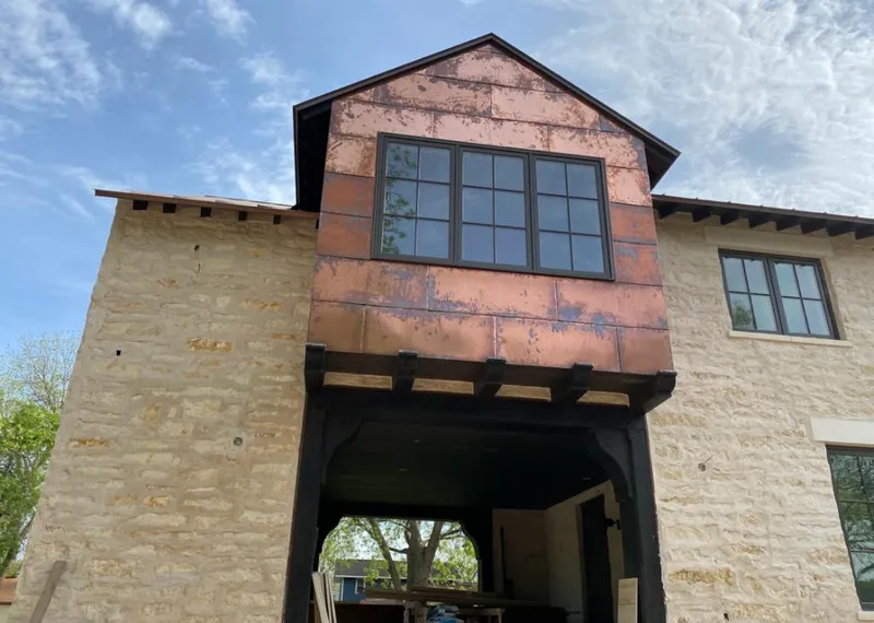 Copper metal panel facade on a stone building for Skylight Installation in Depew